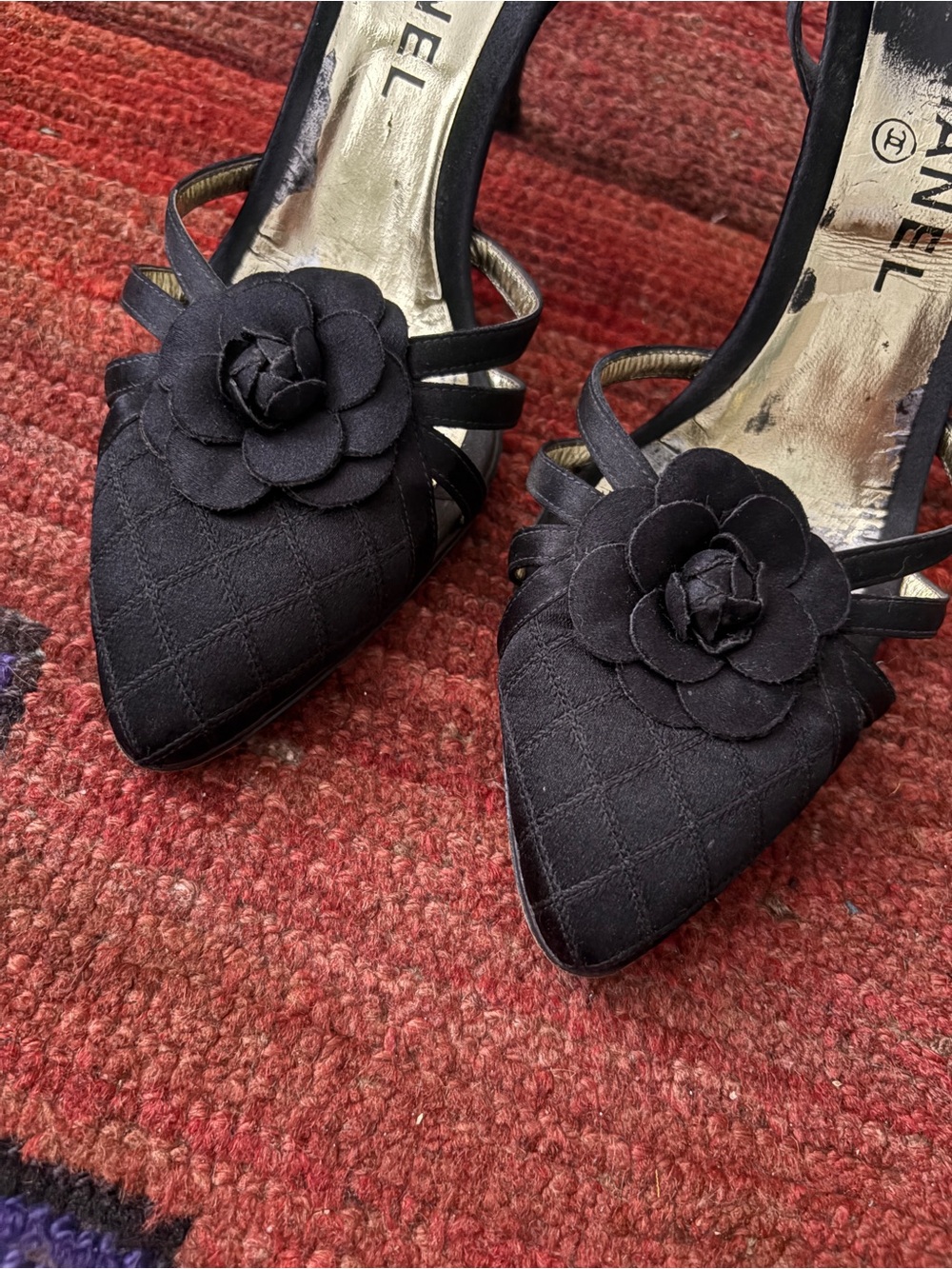 CHANEL Black Quilted Pointed-Toe Slingback Heels with Camellia Detail